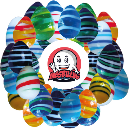 Imagen de la mascota MisCanicas rodeada de Canicas Huevo MisCanicas, forma no convencional, cristal azul intenso rayado blanco y azul, 25 mm. Canicas Huevo MisCanicas, forma no convencional, cristal azul intenso rayado blanco y azul, 25 mm.